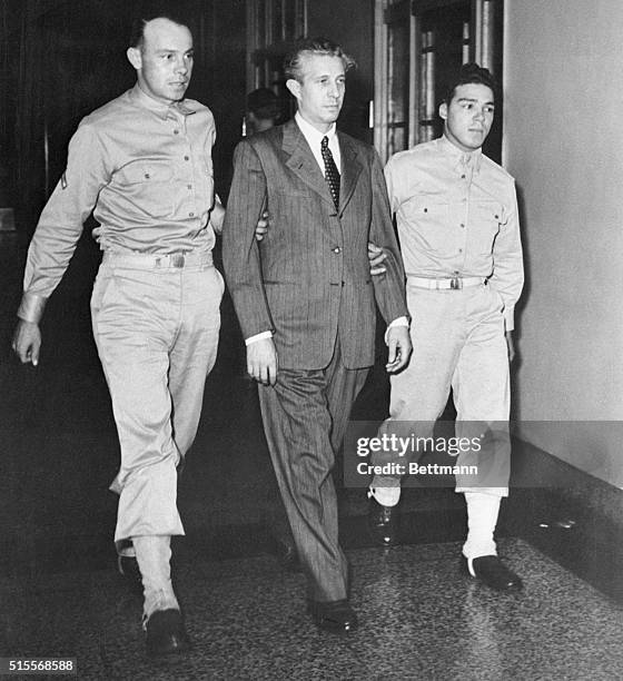 Prisoner Richard Quirin is escorted to the courtroom in the Department of Justice building for the third day's proceedings in the trial of the eight...