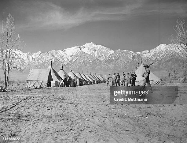 Manzanar, California: Army sentries pace on the boundary of the new Owens Valley Reception Center at Manzanar, California, to be used as a Japanese...