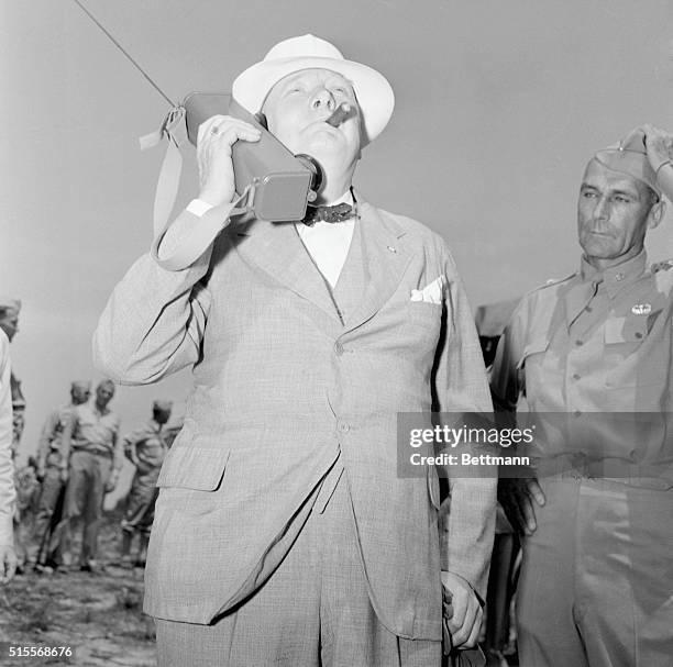 Prime Minister Winston Churchill watches the descent of American paratroopers during his visit at Fort Jackson, South Carolina.