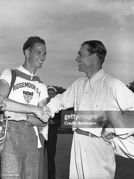 Ben Hogan is shown being congratulated by his caddy, Bill Boston, after winning the Hale America Open Golf Tournament, June 21, at the Ridgemoor...