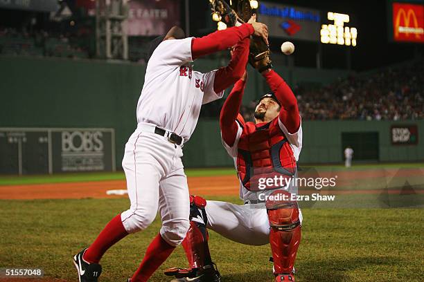 Bill Mueller of the Boston Red Sox and teammate Jason Varitek bobble a foul ball by the St. Louis Cardinals during the second inning of game two of...