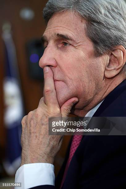 Secretary of State John Kerry listens to President Barack Obama address the Chief of Missions Conference in the Dean Acheson Auditorium at the Harry...