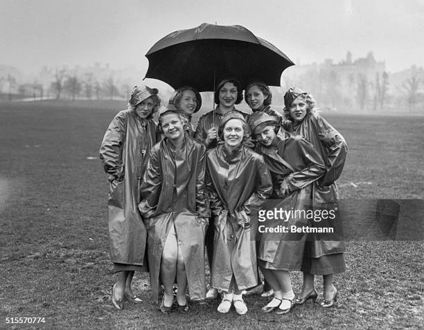 NEW YORK CITY. MEMBERS OF CHESTER HALE TROUPE OF DANCING GIRLS HUDDLED UNDER UMBRELLA IN CENTRAL PARK. MARCH 21,1933