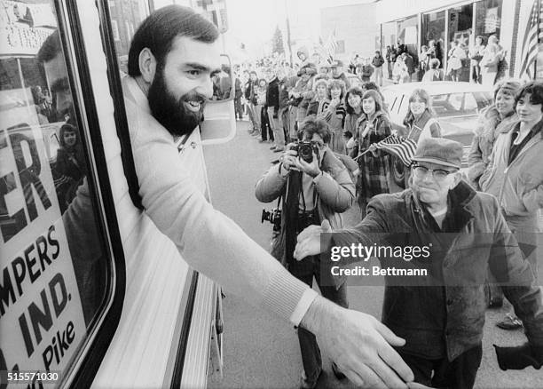 Frederick Lee Kupke reaches out from the window of a van to greet the people who turned out to welcome him home following his release from Tehran. |...