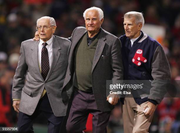 Boston Red Sox Hall of famers Dom Dimaggio, Bobby Doerr and Johnny Pesky walk out onto the field to throw the first pitch of game two of the World...