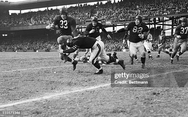 Washington Redskin football player Sammy Baugh tackled by Chicago Bear fullback Will Osmanski just before the first down of the third quarter of the...