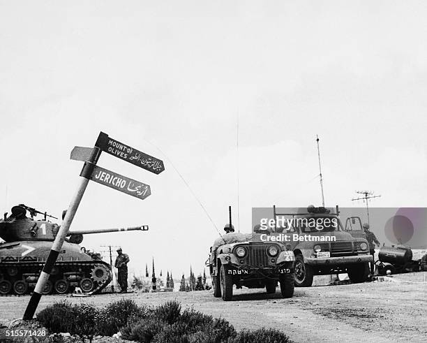 Jerusalem: Israeli mechanized units move through a crossroad in Jerusalem June 7th past a signpost pointing the way to the biblical city of Jericho....