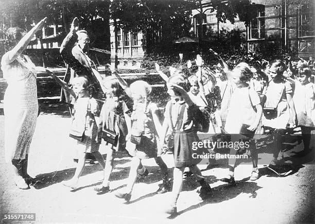 The extent to which Hitlerism is being impressed upon the minds of Germany's youth is revealed in this telling glimpse of little school children...