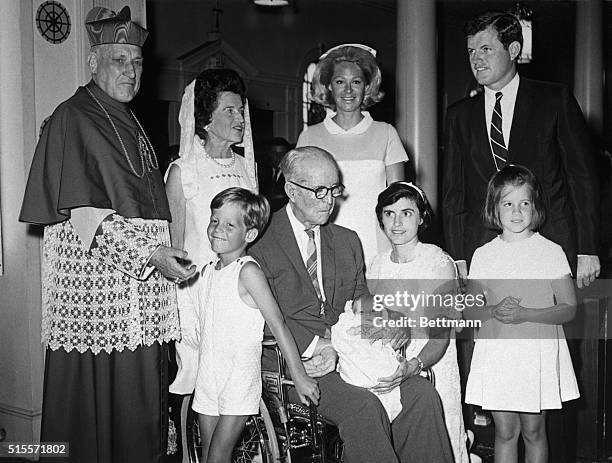 Hyannis, Mass.: Patrick Joseph Kennedy is held by godparents, Joseph P. Kennedy and Ann Gargan following christening at ST. Francis Xavier Church ....