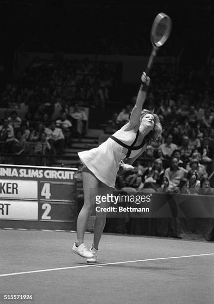Chris Evert overhands one to England's Sue Barker during final of the $150,000 Virginia Slims championship here 3/27. Evert won, 2-6, 6-1, 6-1.