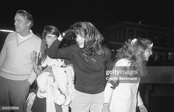 Hyannis Port, Mass.: Mrs. Jacqueline Onassis and daughter, Caroline, look both ways as they looked for John Jr., at airport as Kennedy children and...