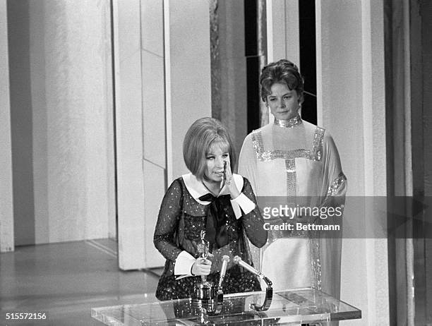 Ingrid Bergman looks on after presenting Barbra Streisand with the Best Actress Oscar at the Academy Awards Ceremony in Los Angeles April 14, 1969....