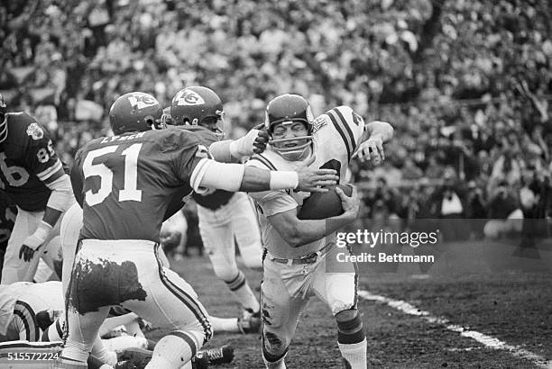 Minnesota Vikings fullback Bill Brown , picks up yardage in first quarter of Super Bowl before being stopped by Kansas City linebacker Jim Lynch .