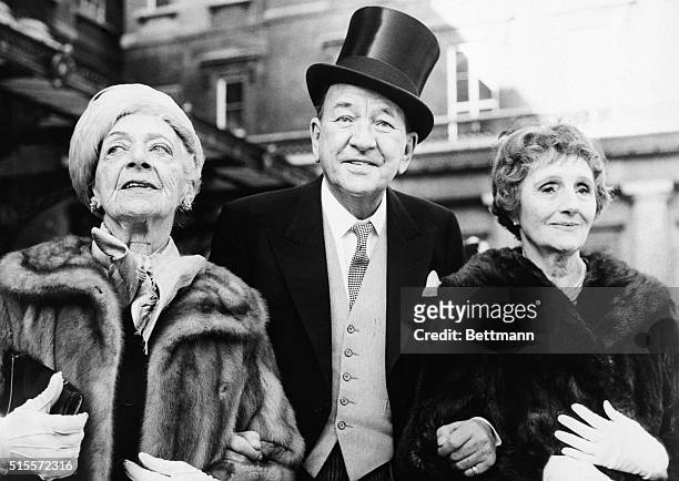 Actor-playwright-composer Sir Noel Coward, accompanied by Mrs. G.E. Calthorp and actress Joyce Carey, leaves Buckingham Palace Feb. 3rd after being...