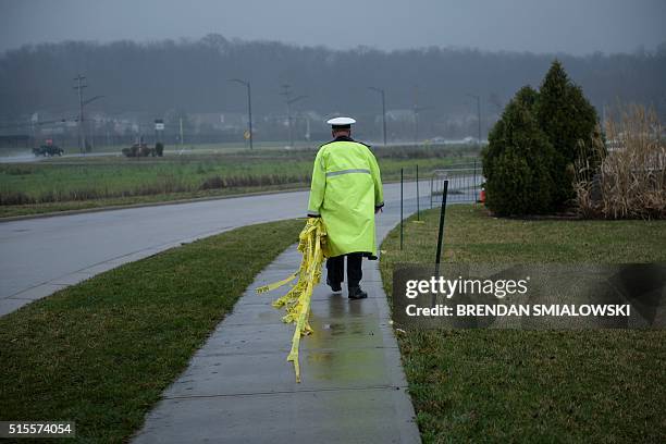 Police officer walks with police tape after a rally for Republican Presidential hopeful Donald Trump March 13, 2016 in West Chester, Ohio. / AFP /...