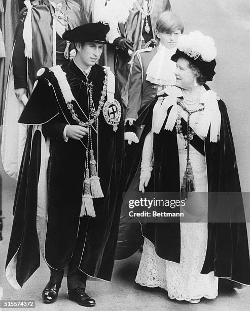 Prince Charles, the Prince of Wales, marches in procession with his grandmother Queen Elizabeth, the Queen Mother, from St. George's Hall to the...