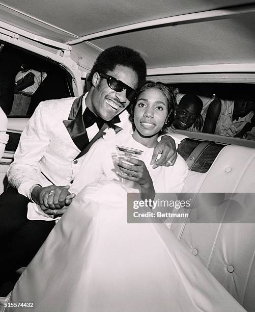 Singing star Stevie Wonder embraces his bride, the former Syreeta Wright, a Motown songwriter and songstress, as they depart Detroit's Bernette...