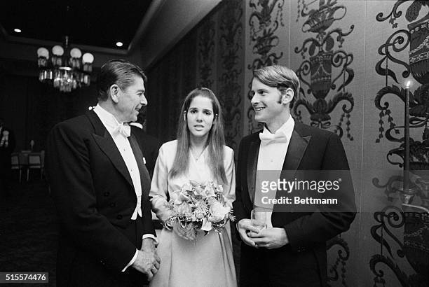Gov. Ronald Reagan {l} greets his daughter Patricia Reagan with escort George W. Vaughan Jr. At the Las Madriines, Beverly Hilton Hotel. Miss Reagan...