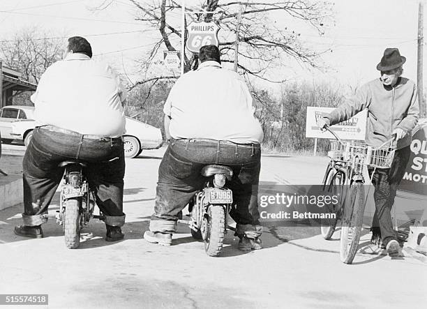 Billy and Benny McCrary stop to put air in their tires at a service station in their hometown of Hendersonville. The twins, who are billed as "the...