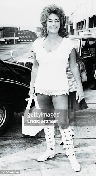 Actress Elizabeth Taylor, a 39-year-old grandmother, arrives at London Airport, July 29th, where she will fly to Monte Carlo to continue holiday with...