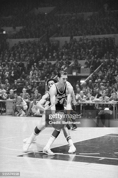 The New York Knicks' defensive ace Walt Frazier has his hands full as he tries to guard the Los Angeles Lakers' scoring champion, Jerry West, during...