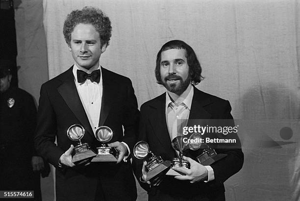 Arthur Garfunkel and Paul Simon hold a "Grammy" for best record and best album of the year for "Bridge Over Troubled Water." Simon holds a third...