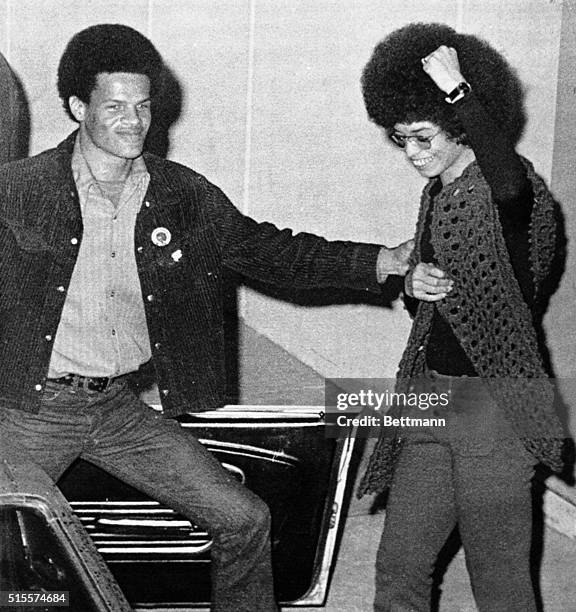 Broadly smiling Angela Davis gives black power salute as she emerges from jail, free on bail after 16 months of imprisonment. Her bail was set at...