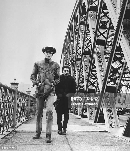 Hoffman and the "Midnight Cowboy" Jon Voight cross New York's Willis Avenue Bridge in a scene from the film, the story of two men who discover...