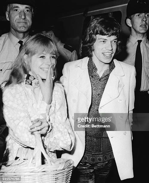 Shown at Euston Station are Mick Jagger, leader of the Rolling Stones, and his girlfriend, Marianne Faithfull, as they boarded a train for Bangor,...