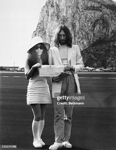 Japanese-born artist & singer Yoko Ono and musician John Lennon hold the marriage certificate following their registry office wedding here on March...