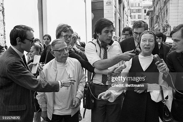 Journalists surround Jean-Paul Sartre And Simone de Beauvoir on a Paris street after their release from police custody. Sartre and de Beauvoir were...