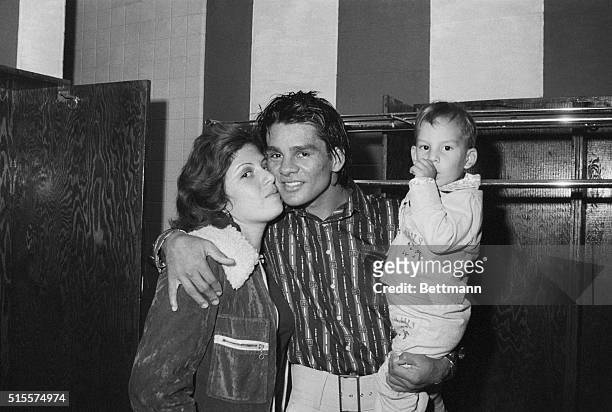 Uniondale, NY:Lightweight champion Roberto Duran holds his son, Roberto Jr. As his wife Claudine kisses him after he won a unanimous decision over...