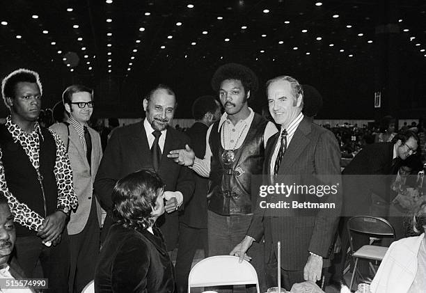 Stopping by for a chat at Hugh Hefner's table during "Operation Push" dinner in Chicago's McCormack Place late 3/10 are: Percy Sutton, Manhattan...