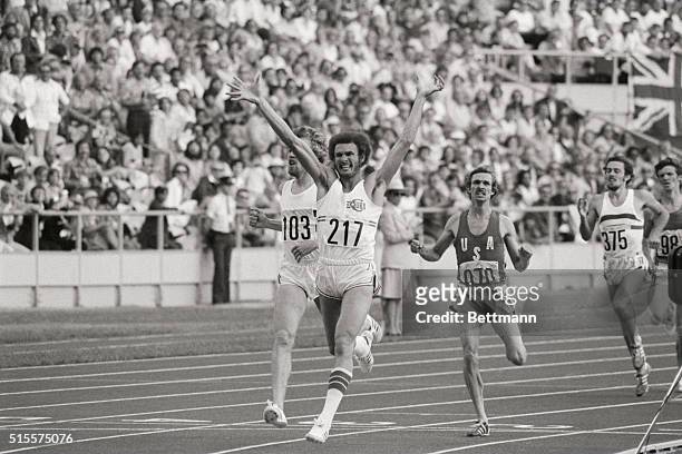 Cuba's Alberto Juantorena raises his arms in victory as he crosses the finish line to win the men's 800 meters race at the 1976 Summer Olympics in...