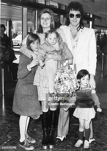 Portrait of Paul McCartney with his wife, Linda, and daughters; Heather, 10; Mary, 3; and Stella, 1; at the airport in London just before leaving for...