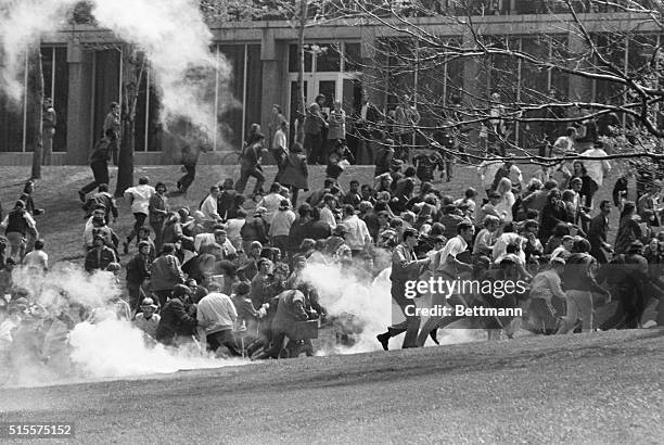 Anti-war demonstrators at Kent State University run as National Guardsmen fire tear gas and bullets into the crowd.