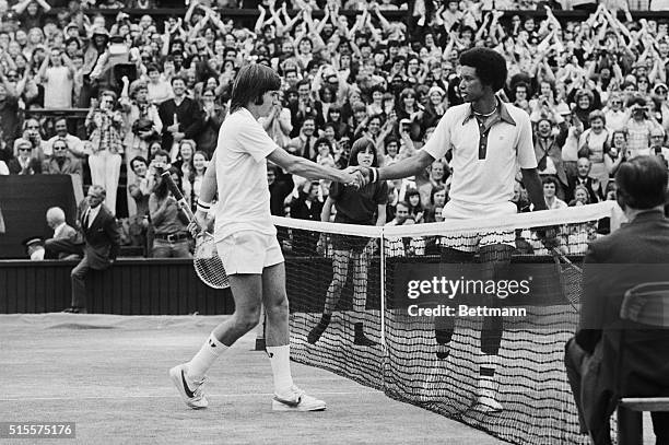 Wimbledon:Artur Ashe, USA and Jimmy Connors, USA shake hands over the net here 7/5, after Ashe had won the men's singles title, with score...