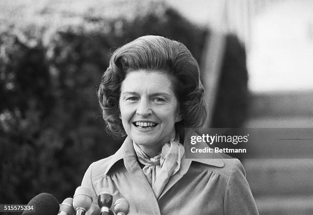 First Lady Betty Ford is all smiles as she talks to newsmen as she leaves nearby Bethesda Naval Hospital 10/11 where she underwent surgery for breast...