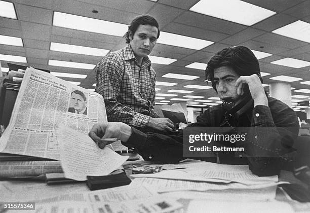 Bob Woodward and Carl Bernstein, Washington Post staff writers who have been investigating the Watergate case, at their desk in the Post.
