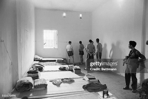 Unidentified group of U.S. POWs turn their backs on a North Vietnamese film cameraman in their cells at the Nga Tu So prison camp in Hanoi. All of...