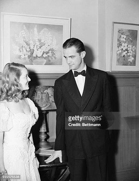 Bette Davis and Howard Hughes attending a charity dinner and dance, at Beverly Hills Hotel in Los Angeles, to help provide shelters for dogs.
