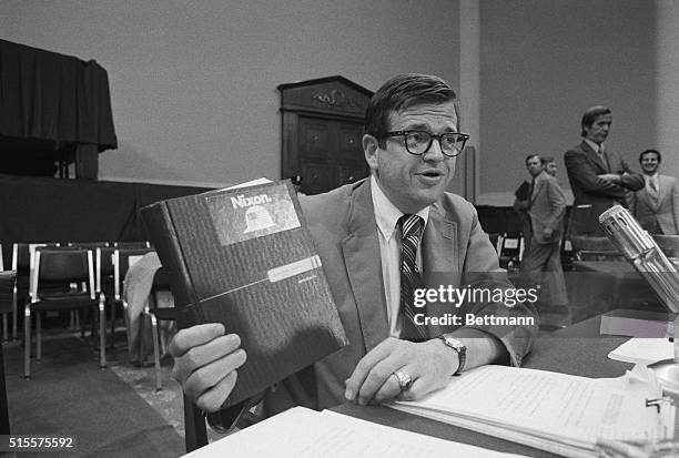 Washington: Former Presidential aide Charles Colson holds up an appointment book with a Nixon decal on it as he prepares to resume his testimony...