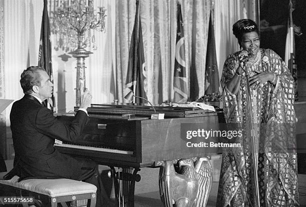 President Richard Nixon plays the piano as Pearl Bailey sings at the White House March 7 during a dinner for the nation's governors and their wives....