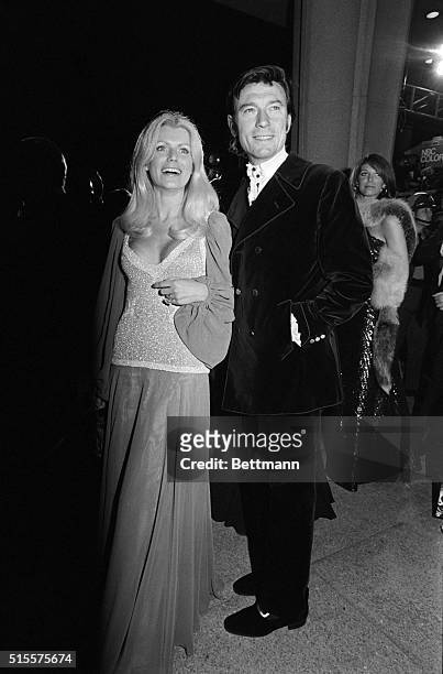 Actor Laurence Harvey and his wife, the former Pauline Stone, shown as they arrived at the Music Center to attend the 458th annual Academy Awards.