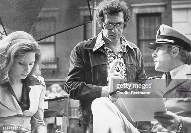 Director Sydney Pollack goes over the script with Barbra Streisand and Robert Redford on the set of the 1973 romance The Way We Were.