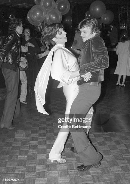 Performer Liza Minnelli and ballet dancer Mikhail Baryshnikov dance together at Studio 54 in Manhattan during a night on the town.
