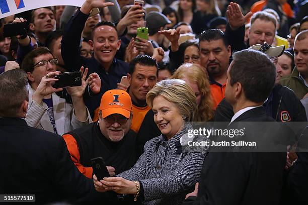 Democratic presidential candidate Hillary Clinton takes selfies with supporters during a "Get Out the Vote" event at the Chicago Journeymen Plumbers...