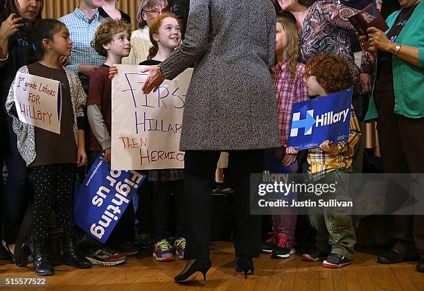 Democratic presidential candidate Hillary Clinton greets children during a "Get Out the Vote" event at the Chicago Journeymen Plumbers Local Union on...