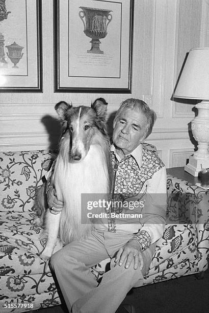 At the Plaza Hotel, Rudd Weatherwax is the owner and trainer of Lassie. Here, he is pictured with the famous dog.