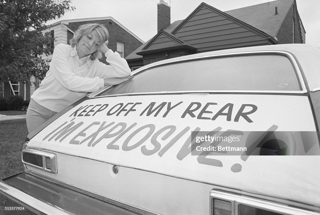 Woman Leaning on Ford Pinto with Warning Sign